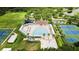 Overhead shot of the neighborhood pool area featuring covered seating, tennis court, and playground at 19635 Bellehurst Loop, Land O Lakes, FL 34638