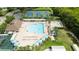 Aerial view of the community pool and clubhouse surrounded by lush landscaping at 19635 Bellehurst Loop, Land O Lakes, FL 34638