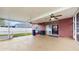 Covered screened-in lanai with ceiling fan, sliding glass door, and concrete flooring; great for outdoor relaxation at 19635 Bellehurst Loop, Land O Lakes, FL 34638