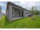 Exterior view of the covered patio and back yard of the property at 212 Villa Luna Ln, Lutz, FL 33549