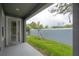View of the fenced back yard with a small tree from the covered patio at 212 Villa Luna Ln, Lutz, FL 33549