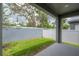 View of the fenced back yard with green grass at 212 Villa Luna Ln, Lutz, FL 33549