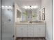 Elegant bathroom boasts double sinks, granite countertop, and a glass enclosed shower providing a spa-like experience at 212 Villa Luna Ln, Lutz, FL 33549