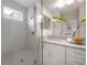 Bright bathroom features a glass-enclosed shower, dual sinks, and granite countertops offering a modern and luxurious feel at 212 Villa Luna Ln, Lutz, FL 33549