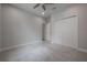 Spacious bedroom features neutral carpet, a ceiling fan, and a double door closet, offering a comfortable and serene space at 212 Villa Luna Ln, Lutz, FL 33549