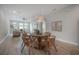 Cozy dining room featuring a round wooden table with wicker chairs and decorative pendant lighting at 212 Villa Luna Ln, Lutz, FL 33549