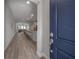 Bright entryway with wood-look tile leading into the open-concept living space at 212 Villa Luna Ln, Lutz, FL 33549