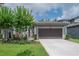 Charming single-Gathering home featuring a well-manicured lawn and a two-car garage at 212 Villa Luna Ln, Lutz, FL 33549