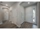 Well-lit hallway with tile floors, multiple doors, and neutral walls provides seamless transition between living spaces at 212 Villa Luna Ln, Lutz, FL 33549