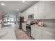 Well-equipped kitchen featuring white cabinetry, stainless steel appliances, and ample counter space at 212 Villa Luna Ln, Lutz, FL 33549