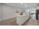 Bright open-concept kitchen with white cabinets, a center island, and modern appliances at 212 Villa Luna Ln, Lutz, FL 33549