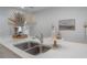 Close-up of a kitchen sink with double basin, white marble countertop and neutral decorations at 212 Villa Luna Ln, Lutz, FL 33549