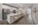 Open kitchen with white cabinets, stainless steel appliances, and an oversized center island at 212 Villa Luna Ln, Lutz, FL 33549