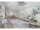 Cozy open concept living room with modern furniture and dining area in background at 212 Villa Luna Ln, Lutz, FL 33549