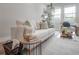Cozy living room featuring a comfortable couch, stylish decor, and bright natural light creating a warm inviting space at 212 Villa Luna Ln, Lutz, FL 33549