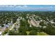 Aerial view of a residential area with tree-lined streets, homes, and the Courtney Campbell Causeway in the distance at 2750 Edenwood St, Clearwater, FL 33759