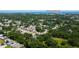 Aerial view of a residential area with tree-lined streets, homes, and the Bayside Bridge in the distance at 2750 Edenwood St, Clearwater, FL 33759
