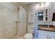 Bathroom featuring a tiled walk-in shower, modern toilet, and granite-topped vanity at 2750 Edenwood St, Clearwater, FL 33759