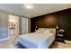 Bedroom showcasing a modern accent wall, nightstand, and ensuite bathroom at 2750 Edenwood St, Clearwater, FL 33759