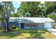 Charming single-story home with a beautifully landscaped front yard and attached garage at 2750 Edenwood St, Clearwater, FL 33759