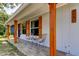 Inviting front porch with stylish seating and wooden columns and trim at 2750 Edenwood St, Clearwater, FL 33759