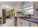 Updated kitchen with stainless steel appliances, granite countertops and white cabinets at 2750 Edenwood St, Clearwater, FL 33759