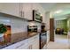 Updated kitchen with stainless steel appliances, white cabinets and granite countertops at 2750 Edenwood St, Clearwater, FL 33759