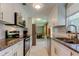 Updated kitchen with stainless steel appliances, granite countertops and white cabinets at 2750 Edenwood St, Clearwater, FL 33759