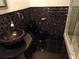 Modern bathroom features black tiling and a vessel sink at 31 Freshwater Dr, Palm Harbor, FL 34684