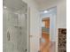Elegant bathroom with a frameless glass shower, marble tile, and modern fixtures at 31 Freshwater Dr, Palm Harbor, FL 34684