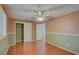 Bright bedroom with hardwood floors, a ceiling fan, and a closet providing ample storage space at 31 Freshwater Dr, Palm Harbor, FL 34684