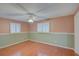 Bedroom with neutral-tone walls, white trim, a ceiling fan, and hardwood floors offering a cozy atmosphere at 31 Freshwater Dr, Palm Harbor, FL 34684