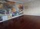 Bedroom with mural and wood floors at 31 Freshwater Dr, Palm Harbor, FL 34684
