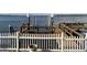 Wooden dock featuring a boat lift and a white picket fence for added safety and charm, with a view of the calm waters at 31 Freshwater Dr, Palm Harbor, FL 34684