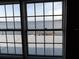 Window view of a dock and waterway, showcasing the waterfront property's serene and accessible water access at 31 Freshwater Dr, Palm Harbor, FL 34684