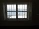 Inviting lake view through large double-paned windows providing natural light and serene scenery of the pier at 31 Freshwater Dr, Palm Harbor, FL 34684