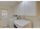 Bright laundry room with modern appliances and overhead storage at 31 Freshwater Dr, Palm Harbor, FL 34684