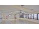 Expansive living room with gleaming marble floors, a ceiling fan, and large windows showcasing waterfront views at 31 Freshwater Dr, Palm Harbor, FL 34684
