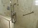 Modern shower featuring tile accents, glass door, and safety grab bars for enhanced comfort and convenience at 31 Freshwater Dr, Palm Harbor, FL 34684