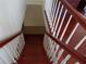 Beautiful cherry wood staircase with white spindles, offering a grand entrance and classic architectural detail at 31 Freshwater Dr, Palm Harbor, FL 34684