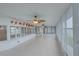 Bright sunroom featuring tile floors, fans, and multiple sliding glass doors at 31 Freshwater Dr, Palm Harbor, FL 34684