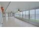 Spacious sunroom with tile flooring, ceiling fans, and panoramic water views at 31 Freshwater Dr, Palm Harbor, FL 34684