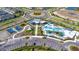 Aerial view of the community amenities featuring a resort-style pool, playground, common spaces and surrounding residences at 31355 Amberview Bnd, Wesley Chapel, FL 33545