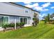 A well maintained backyard with lush green grass and a sliding glass door leading into the home at 31355 Amberview Bnd, Wesley Chapel, FL 33545