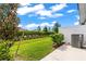 A beautifully landscaped backyard with green grass and a privacy fence surrounding the perimeter at 31355 Amberview Bnd, Wesley Chapel, FL 33545