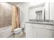 Well-lit bathroom showcasing granite countertops, a shower-tub combo, and elegant neutral color palette at 31355 Amberview Bnd, Wesley Chapel, FL 33545