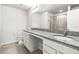 Bright bathroom with granite counters, dual sinks, and a glass enclosed shower, offering modern luxury and convenience at 31355 Amberview Bnd, Wesley Chapel, FL 33545