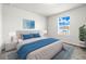Primary bedroom with a blue accent rug, large window, and view of back yard at 31355 Amberview Bnd, Wesley Chapel, FL 33545