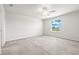 Bright bedroom with a ceiling fan and a large window offering plenty of natural light for a peaceful retreat at 31355 Amberview Bnd, Wesley Chapel, FL 33545