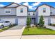 Charming townhome with well-manicured lawn, two-car garage, and modern facade at 31355 Amberview Bnd, Wesley Chapel, FL 33545